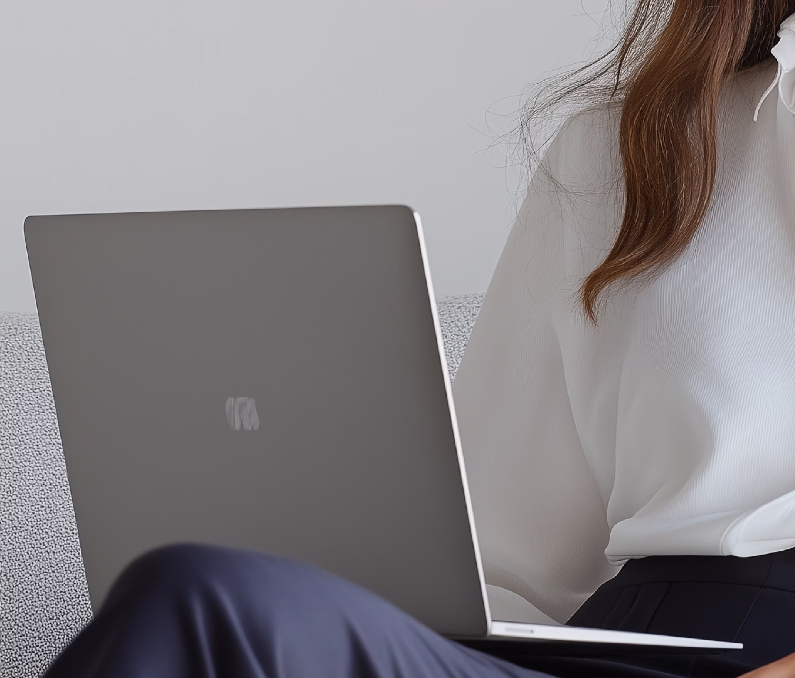 Professional working on a laptop, side angle
